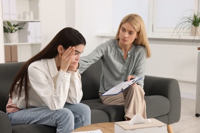 Photo of Psychologist working with teenage girl in office. Teenager problems