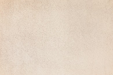 Photo of Texture of beige plaster wall as background