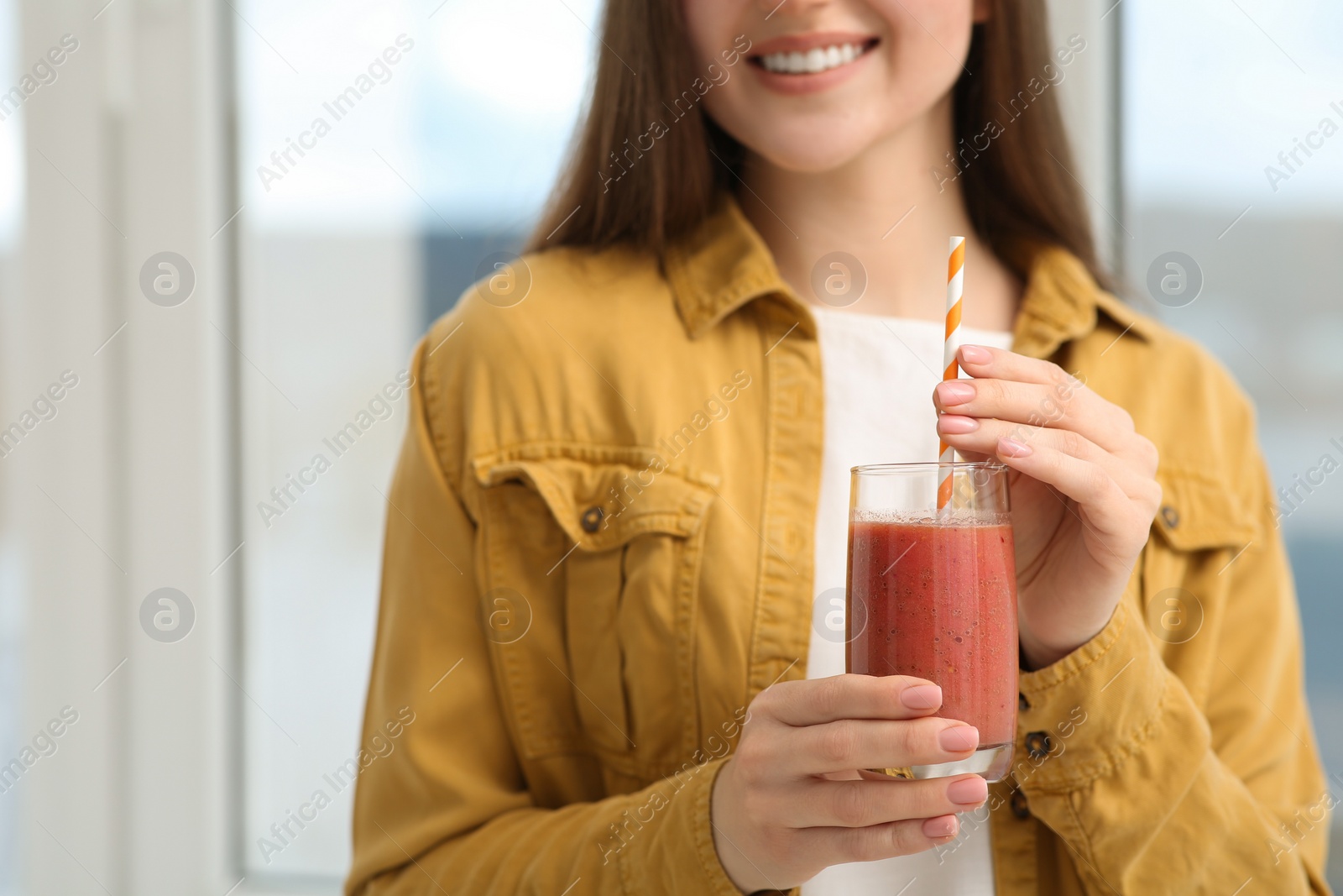 Photo of Woman with delicious smoothie indoors, closeup view