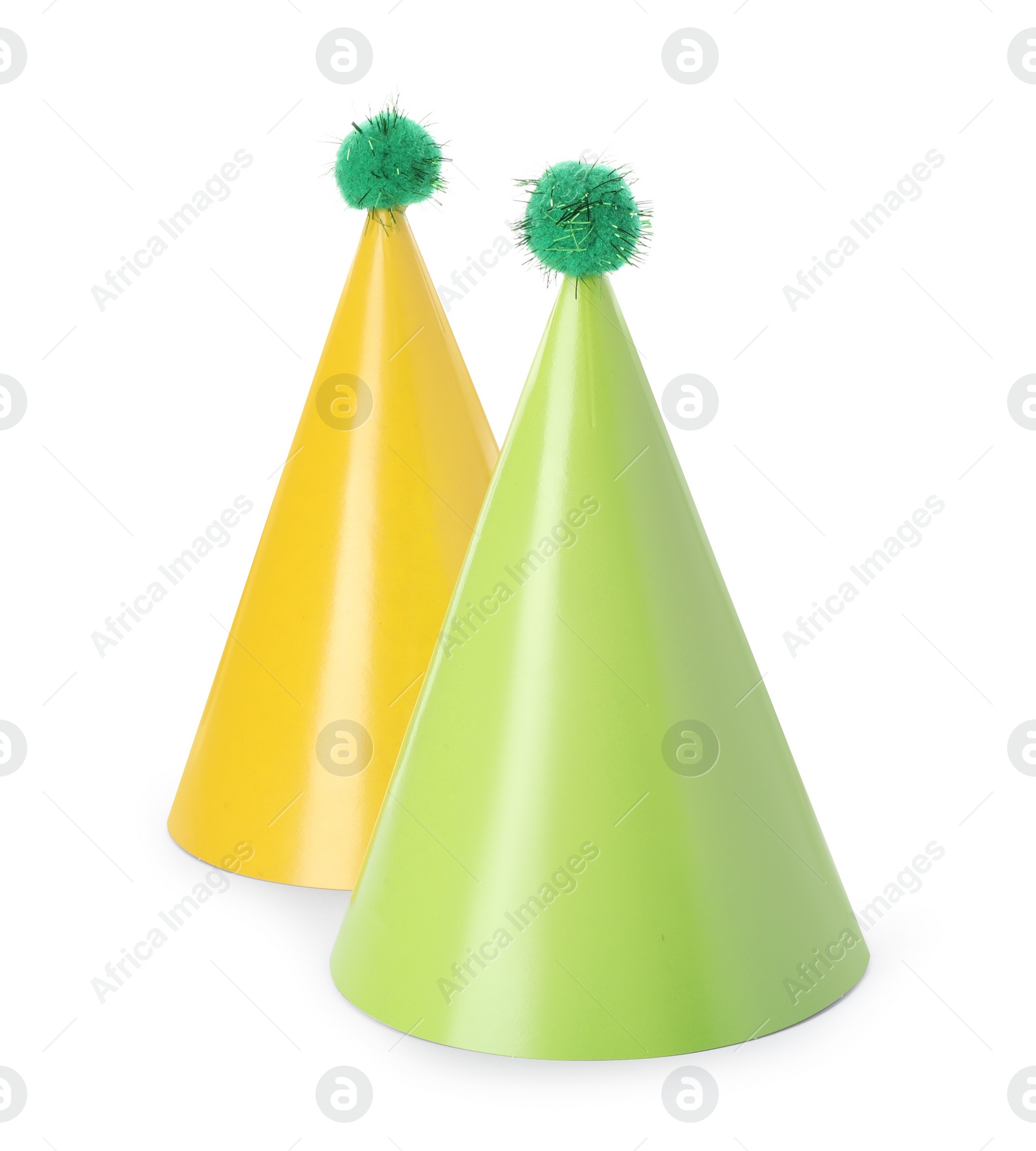 Photo of Two colorful party hats with pompoms isolated on white