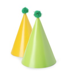 Photo of Two colorful party hats with pompoms isolated on white