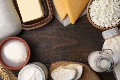 Photo of Frame of different fresh dairy products on wooden table, flat lay. Space for text