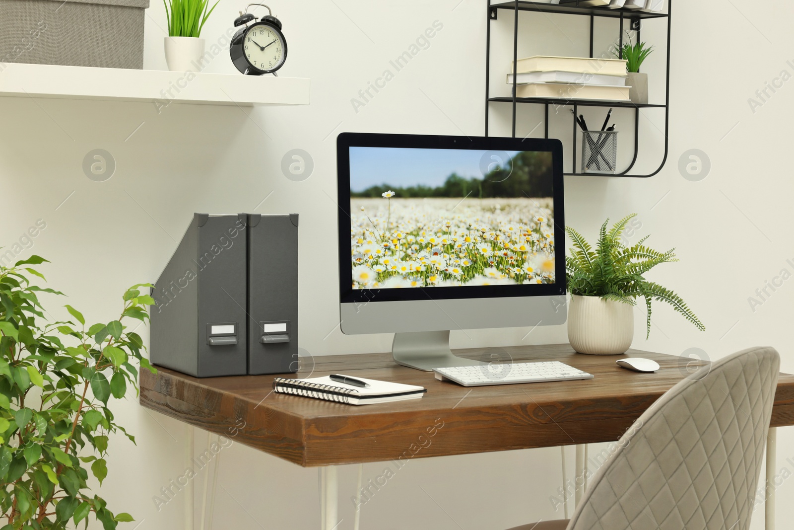 Photo of Cozy workspace with computer on wooden desk at home