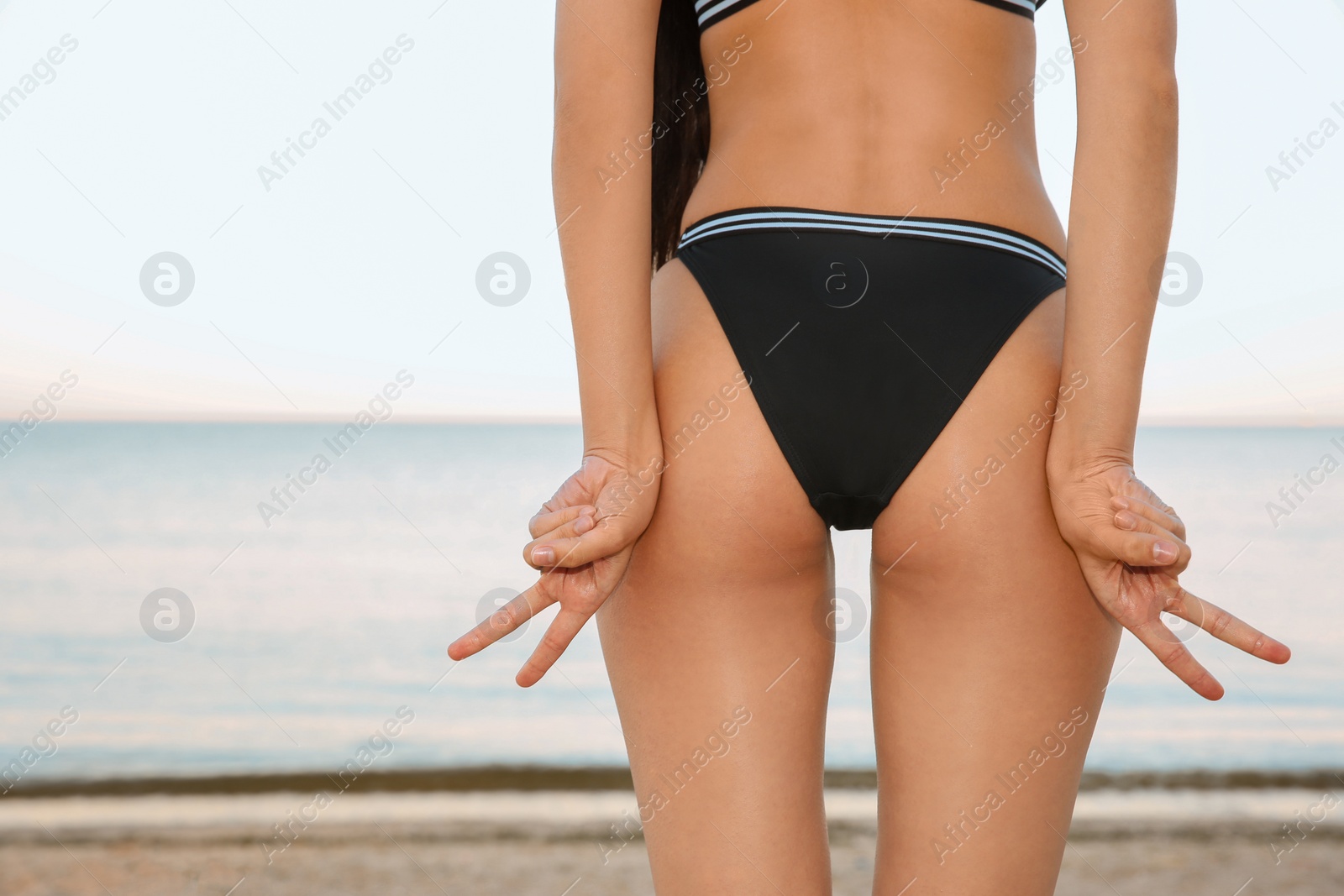 Photo of Young woman in swimsuit at seaside. Summer vacation
