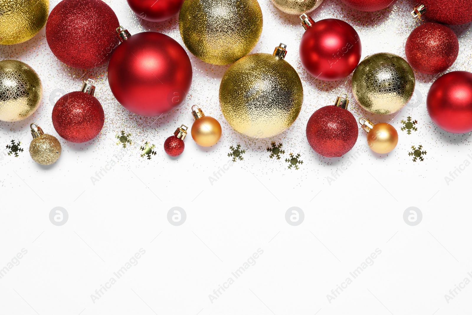 Photo of Christmas balls, confetti and glitter on white background, flat lay. Space for text