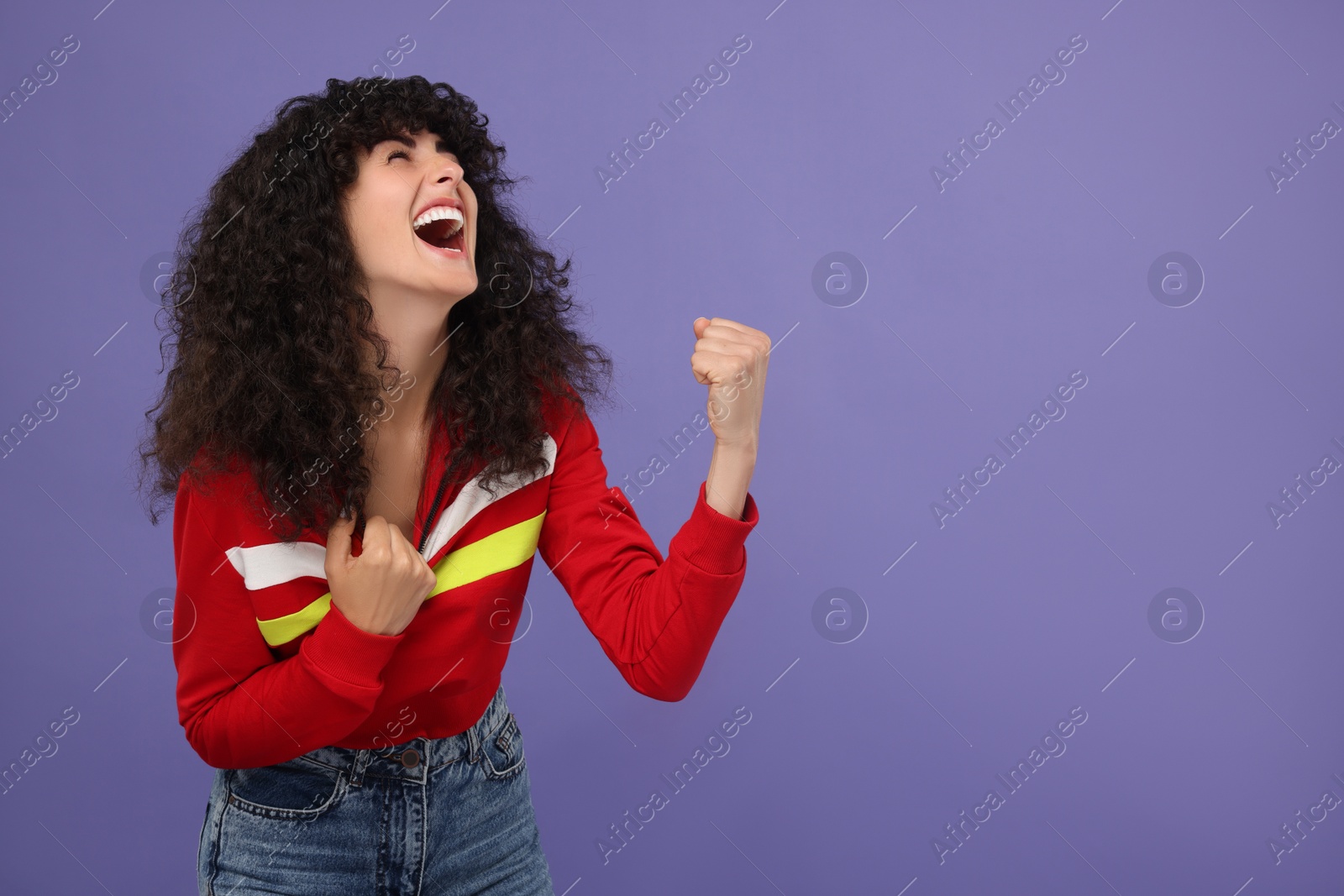 Photo of Happy sports fan celebrating on violet background, space for text