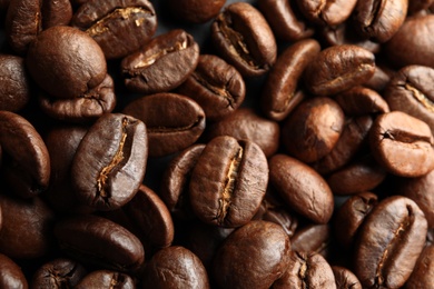 Roasted coffee beans as background, top view