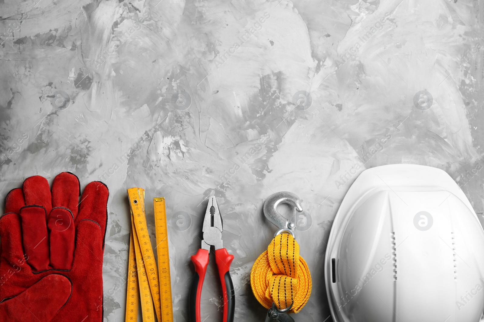 Photo of Flat lay composition with construction tools on grey background, space for text