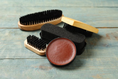 Composition with shoe care accessories on wooden background, closeup