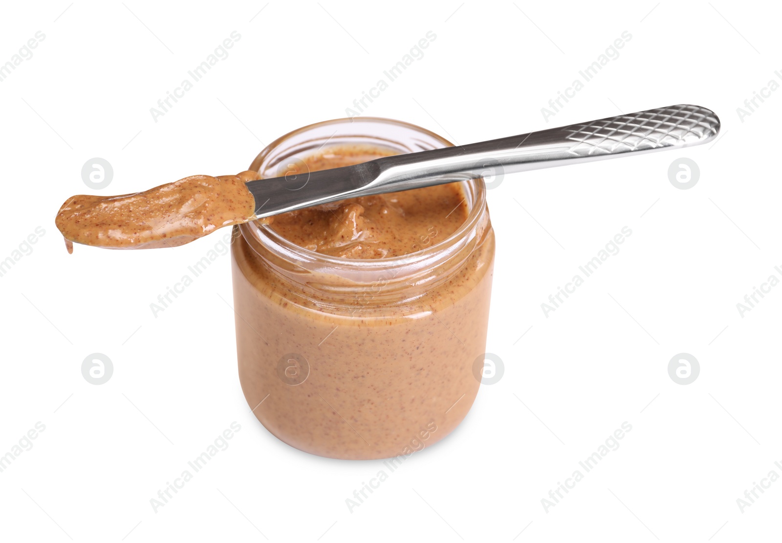 Photo of Tasty nut paste in jar and knife isolated on white