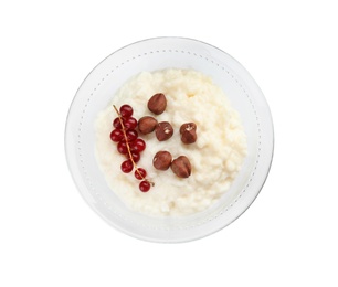 Photo of Creamy rice pudding with red currant and hazelnuts in bowl on white background, top view