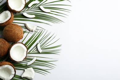 Creative composition with coconuts on white background, top view