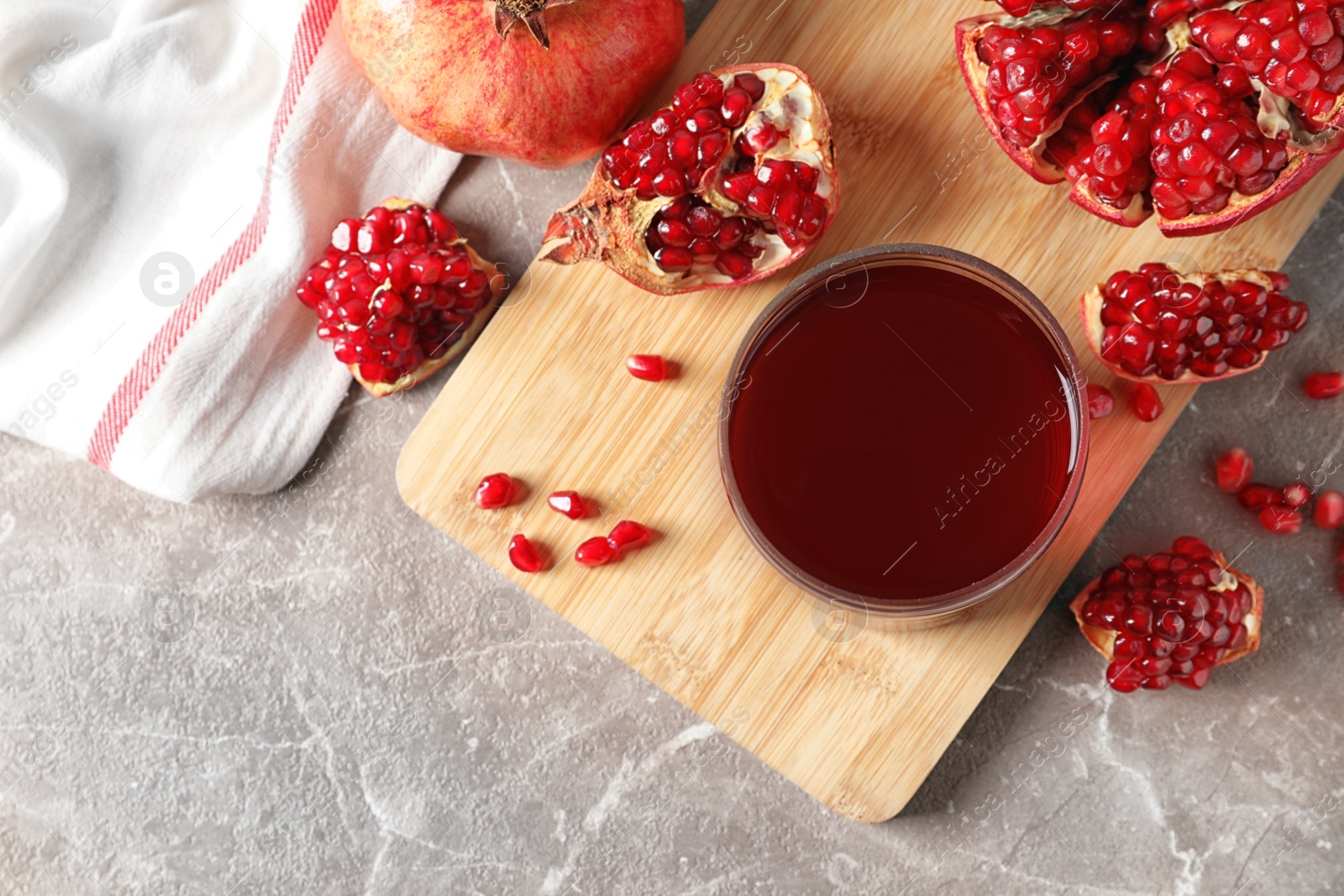 Photo of Flat lay composition with pomegranate juice, fruit and seeds on table