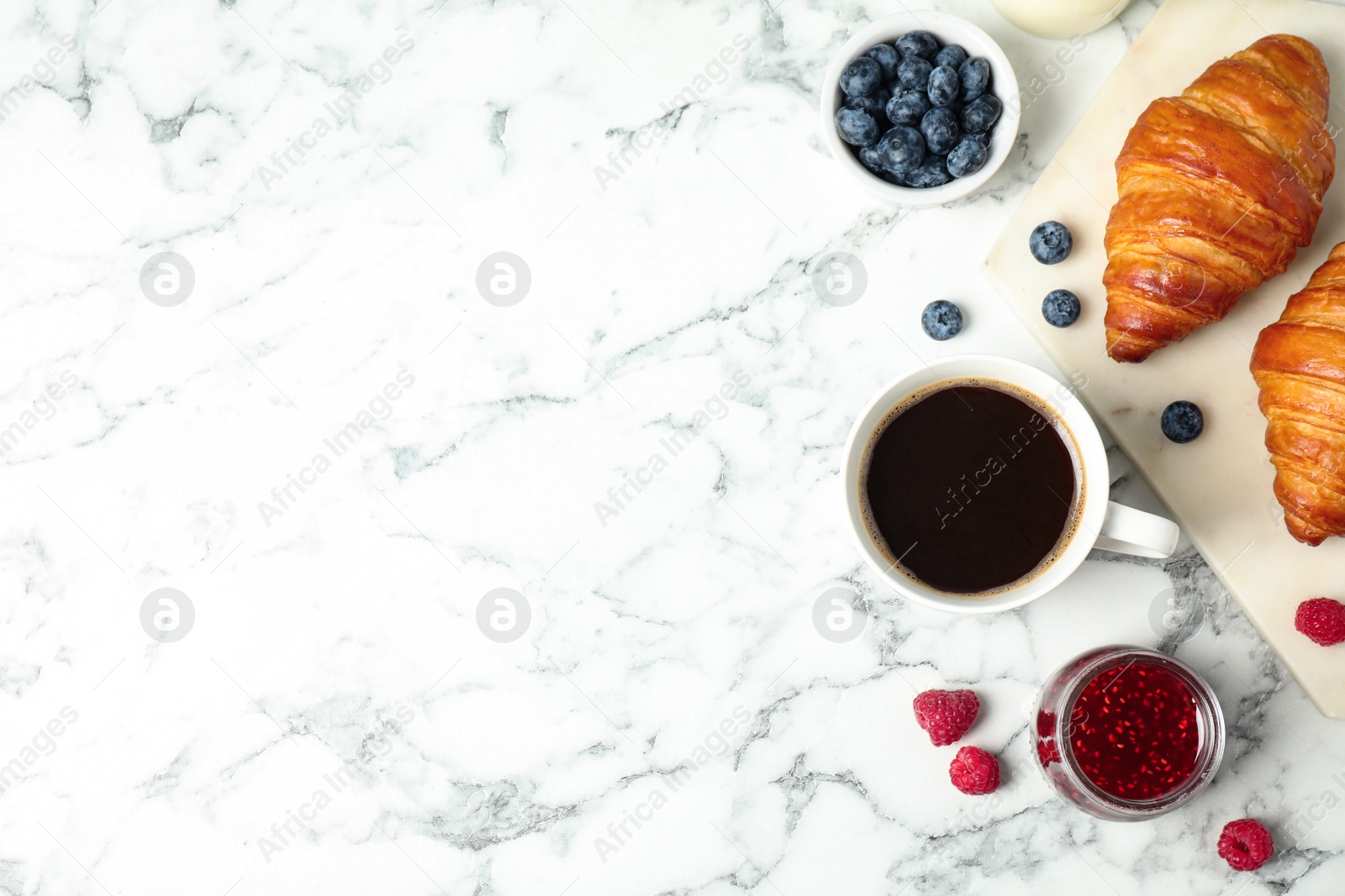 Photo of Tasty breakfast served on white marble table, flat lay. Space for text