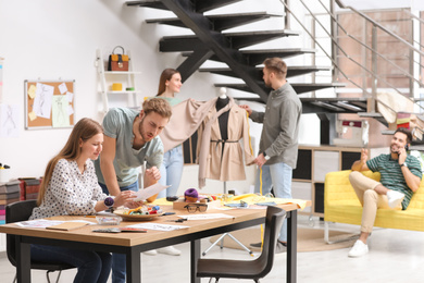 Fashion designers creating new clothes in studio