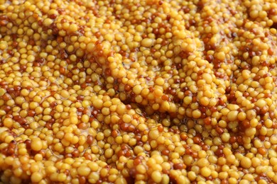 Photo of Whole grain mustard as background, closeup view