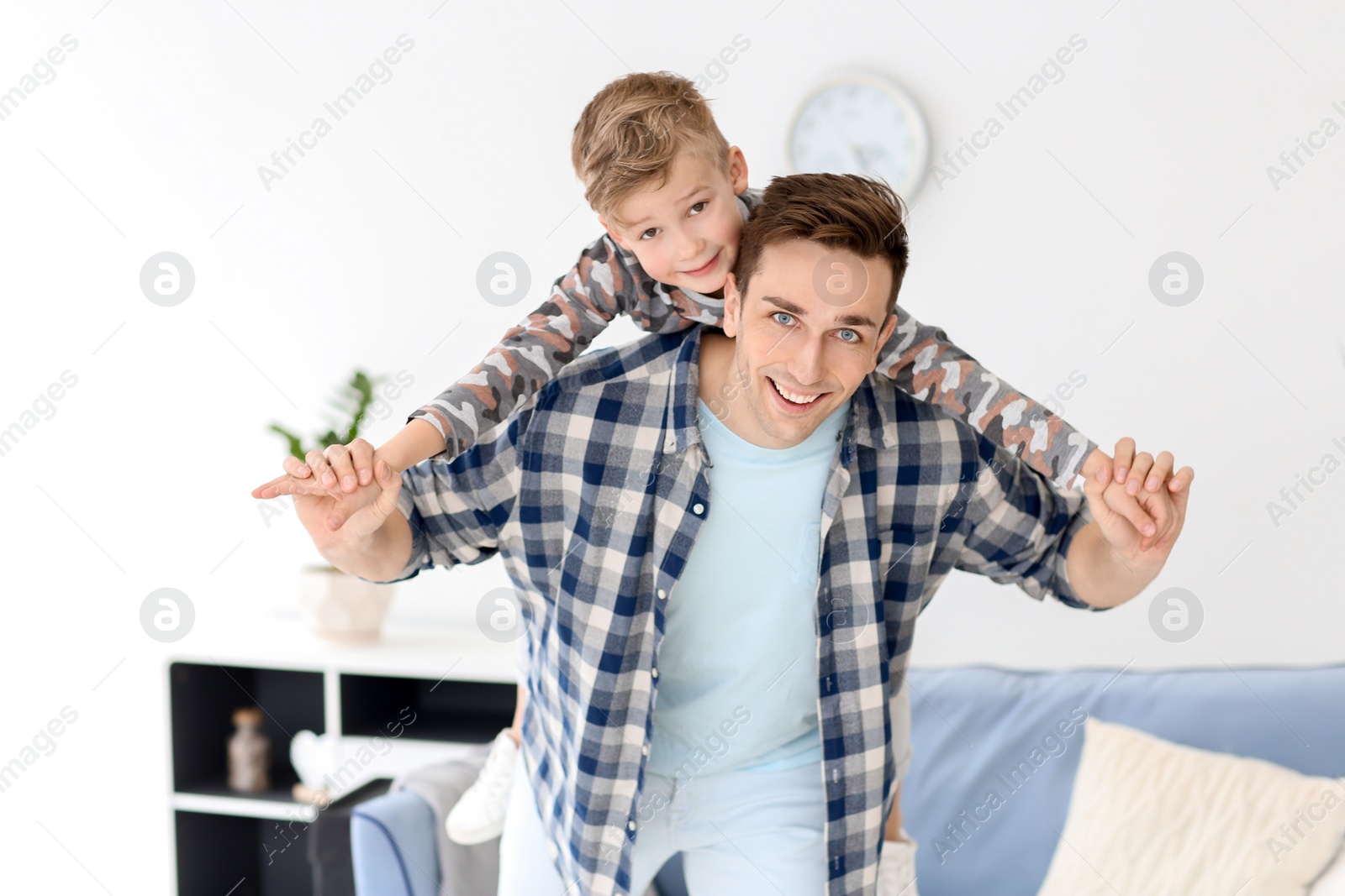 Photo of Dad and his son having fun at home