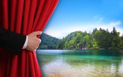 Image of Man opening red front curtain and picturesque view of river and mountains on background