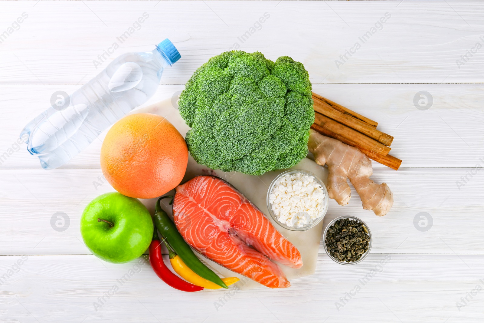 Photo of Metabolism. Different food products on white wooden table, flat lay