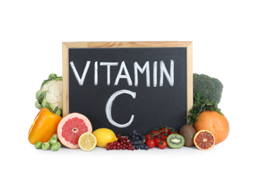 Photo of Chalkboard with phrase VITAMIN C and fresh products on white background