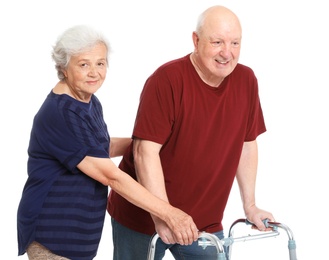 Photo of Elderly woman helping her husband with walking frame on white background