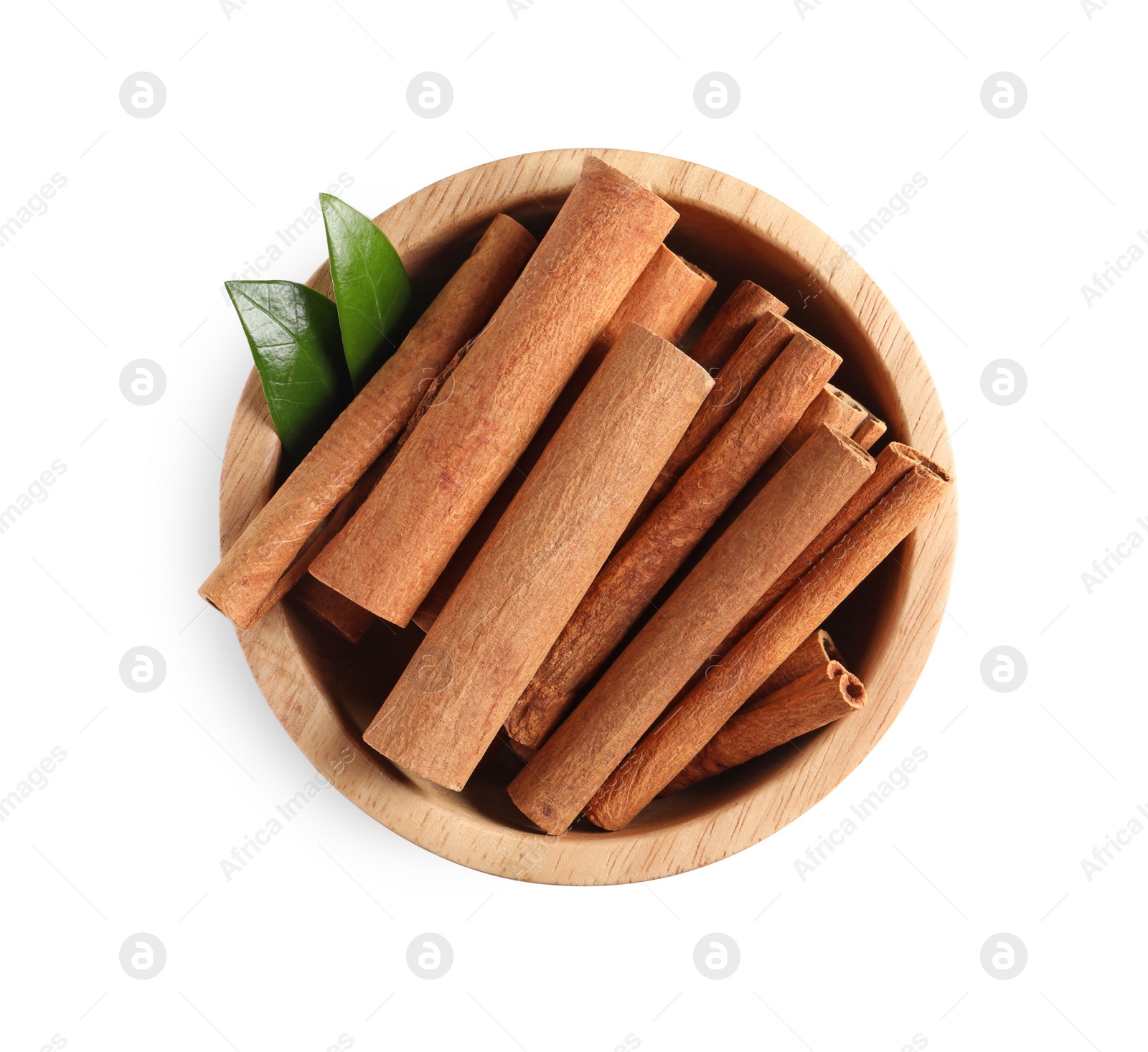 Photo of Cinnamon sticks and green leaves in bowl isolated on white, top view