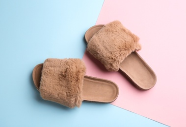 Pair of soft slippers on color background, flat lay