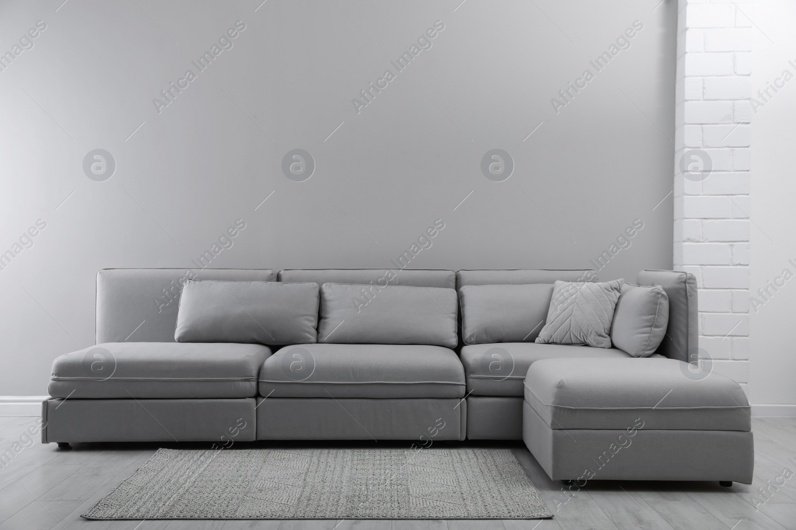 Photo of Large grey sofa in living room. Interior design