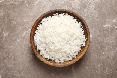 Photo of Plate of tasty cooked rice on color background, top view