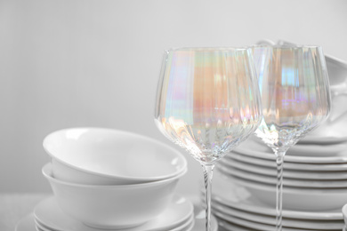 Set of clean dishes and glasses on table