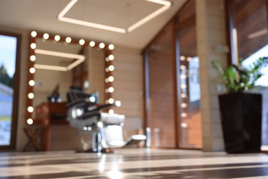 Blurred view of stylish barbershop interior with hairdresser workplace