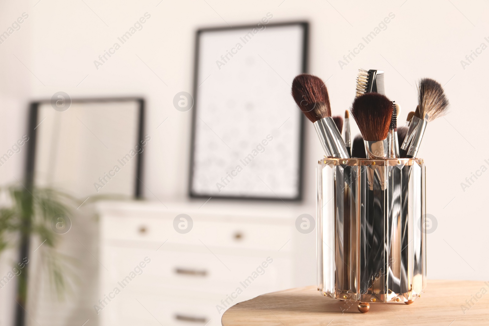 Photo of Set of professional brushes on wooden table indoors, space for text
