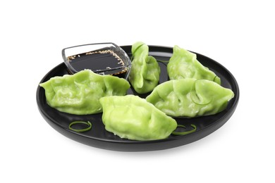 Photo of Delicious green dumplings (gyozas) and soy sauce isolated on white
