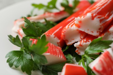 Photo of Crab sticks and parsley on plate, closeup