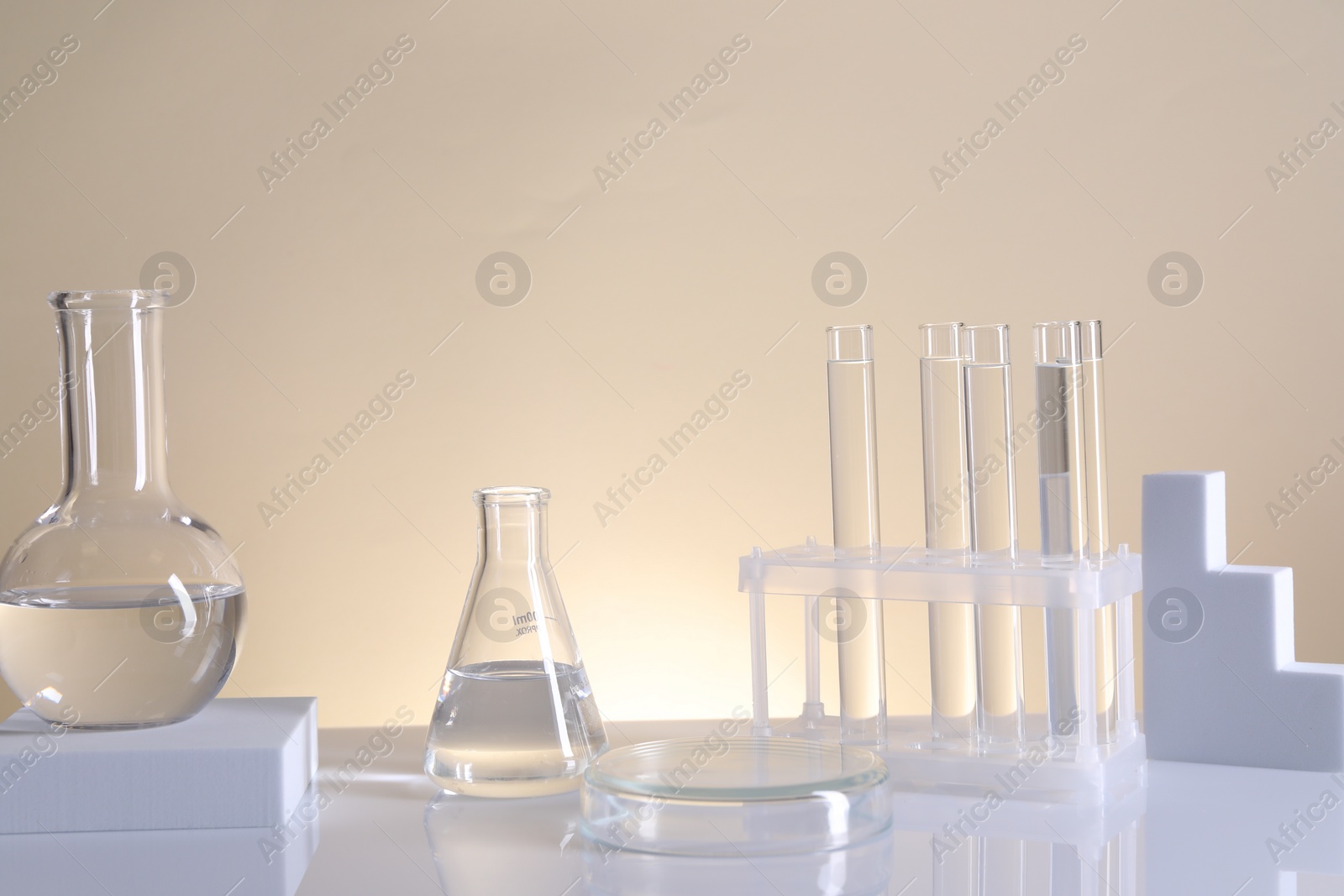 Photo of Laboratory analysis. Different glassware on table against beige background