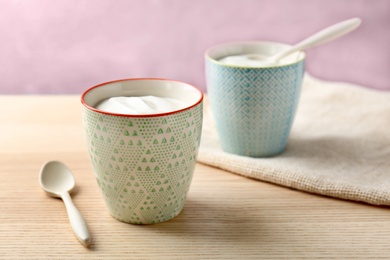 Cups with tasty yogurt on table