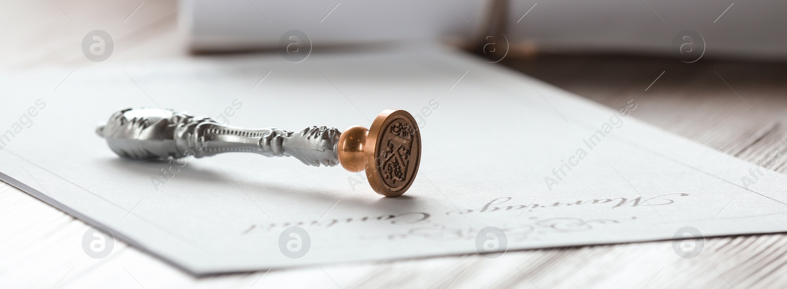 Image of Vintage notary stamp and document on wooden table, closeup. Banner design