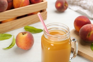 Natural freshly made peach juice on white table, closeup