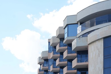 Photo of Beautiful building with balconies against sky, low angle view