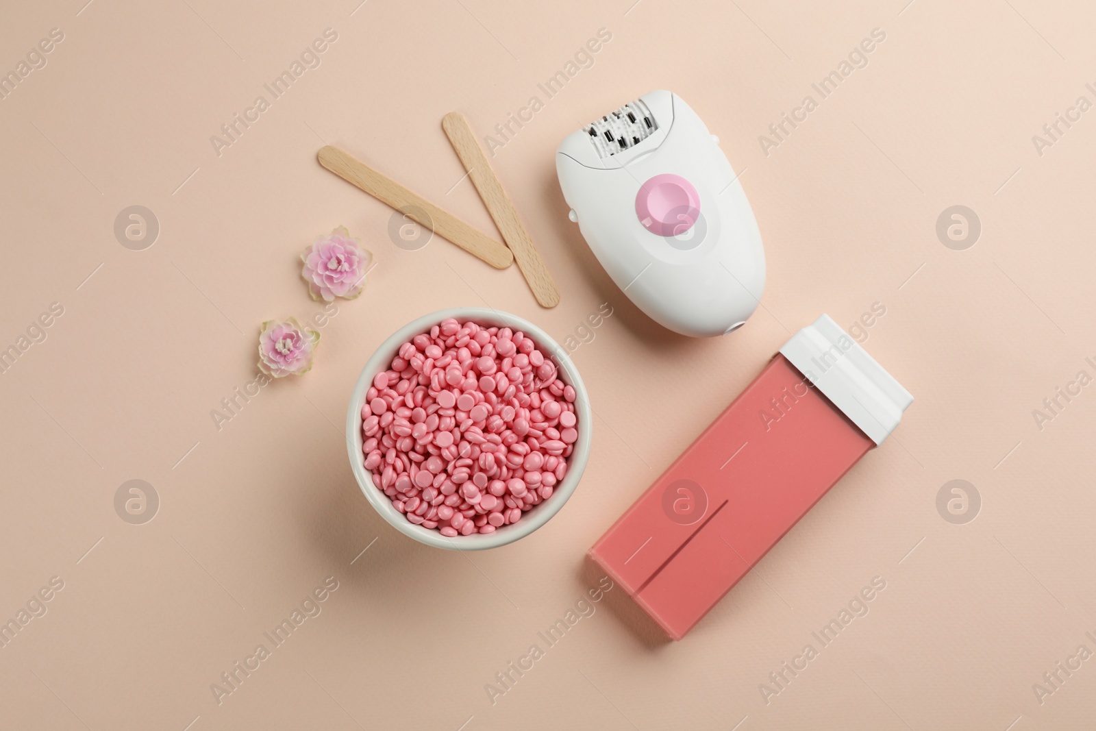 Photo of Set of epilation products on beige background, flat lay