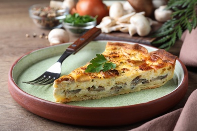 Photo of Delicious pie with mushrooms and cheese on brown wooden table, closeup