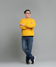Photo of Full length portrait of happy man on grey background. Space for text
