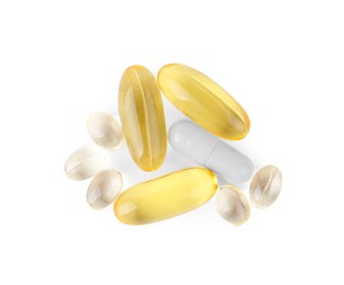 Photo of Different vitamin capsules isolated on white, top view