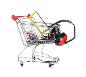 Small shopping cart with hacksaw, gloves and headphones isolated on white