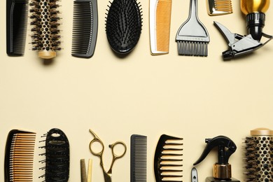 Photo of Hairdressing tools on beige background, flat lay. Space for text
