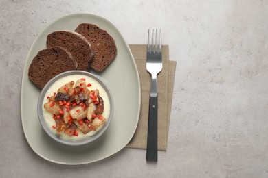 Potato puree and tasty fried cracklings served on light table, flat lay with space for text. Cooked pork lard