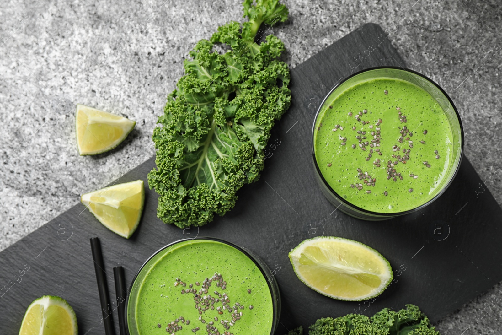 Photo of Flat lay composition with tasty kale smoothie on grey table