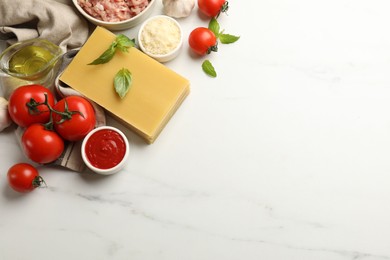 Photo of Ingredients for lasagna on white marble table, flat lay. Space for text