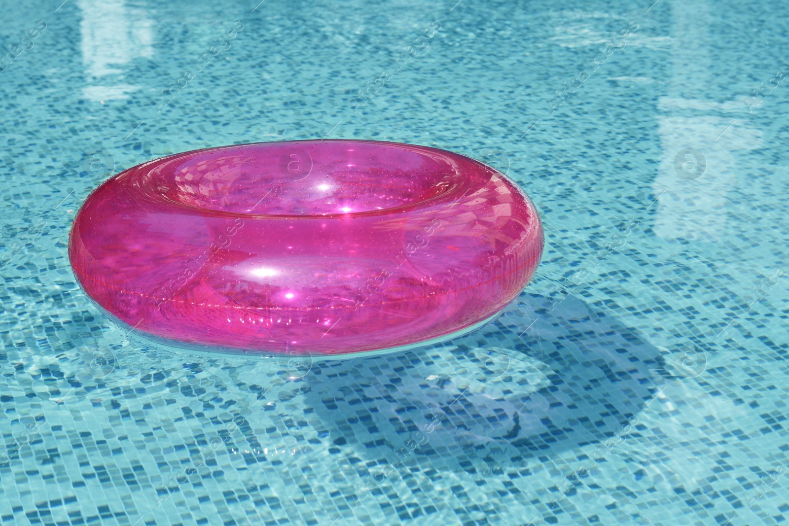 Photo of Inflatable ring floating on water in swimming pool