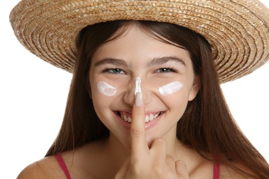 Teenage girl with sun protection cream on her face against white background, closeup